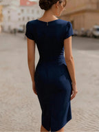 A Midi Dress With A Ruffled Neckline And A Fitted, Bodycon Silhouette.