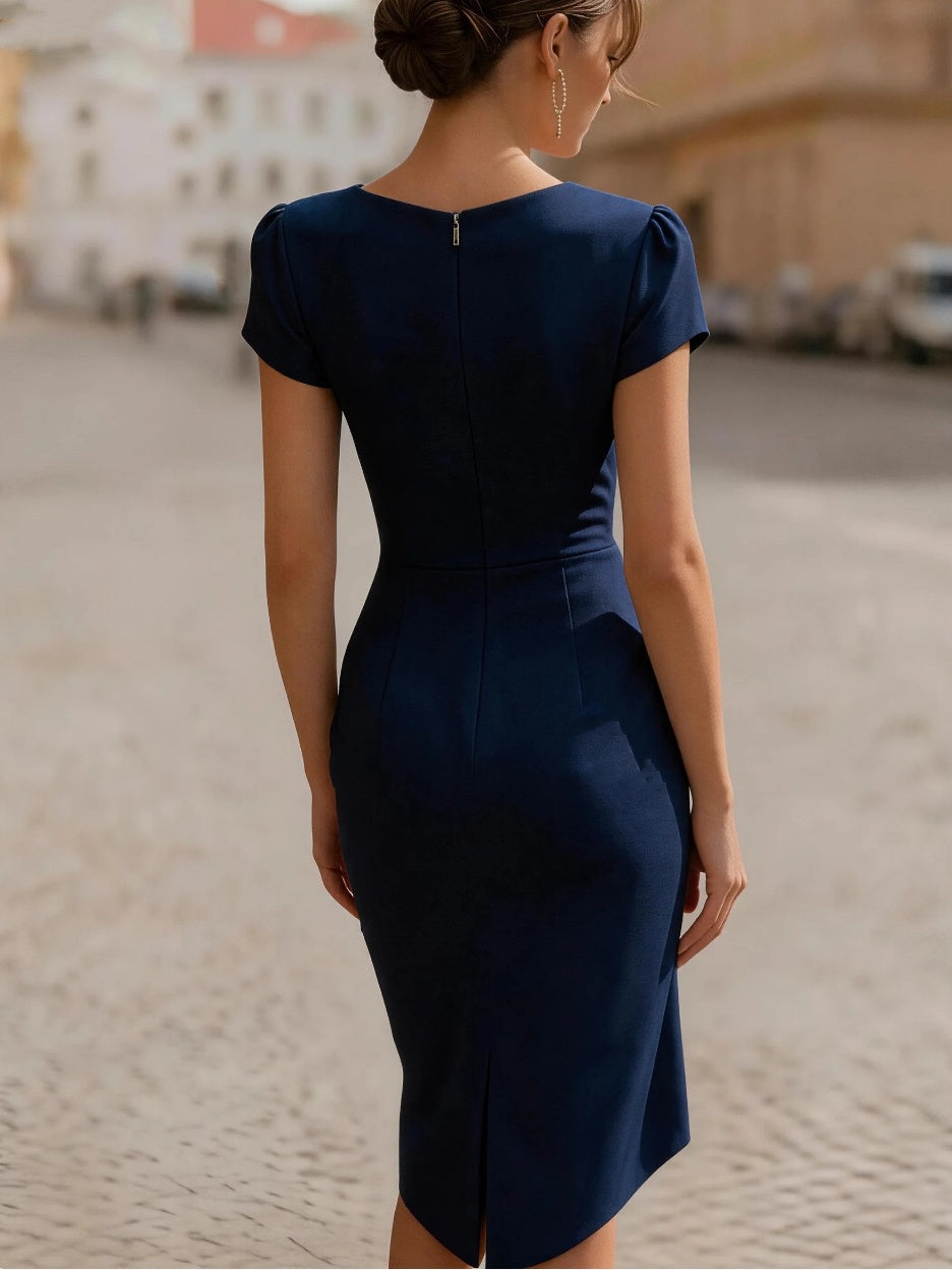 A Midi Dress With A Ruffled Neckline And A Fitted, Bodycon Silhouette.