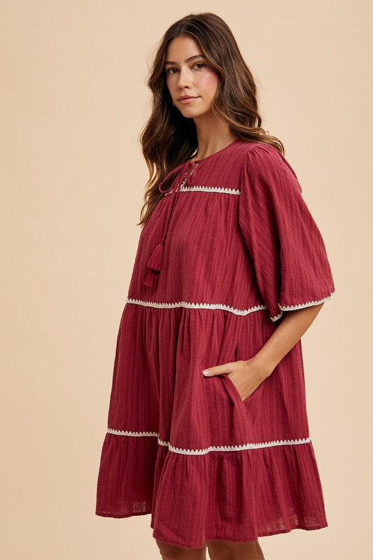 Aaliyah Boutique Tiered Dress with Tassels and Contrast Trim, Tied Neckline, Half Sleeves Designer Edit