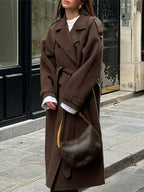 | Elegant maxi coat in a neutral color with double row of buttons and belt