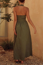 | Sleeveless dress with pocket pleats and halterneck